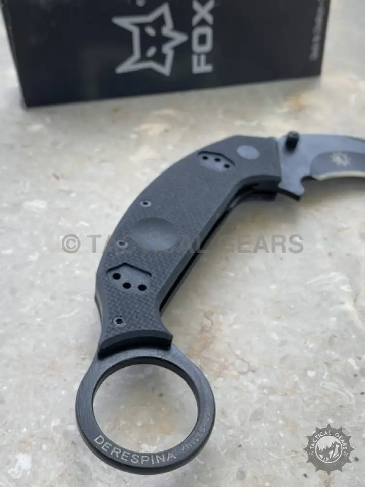 Black folding karambit knife with ring pommel by Fox Knives, a sleek folding karambit design