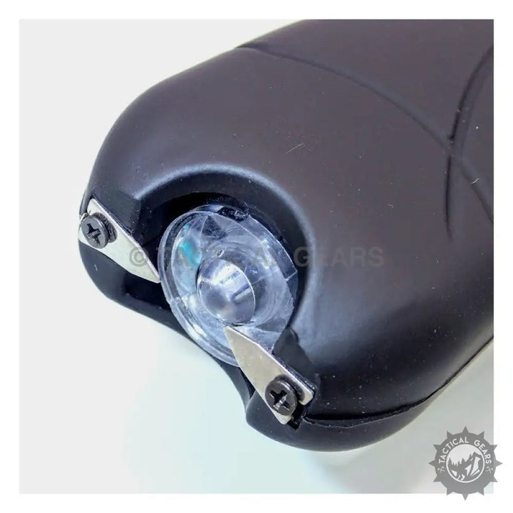 Black stun gun with clear flashlight lens and metal electrodes for self-defense protection