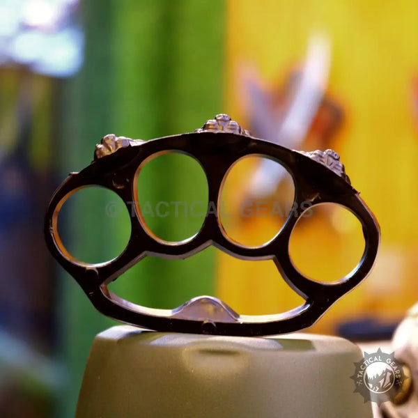 Black four-finger punch knuckle with lion faces for a bold statement accessory