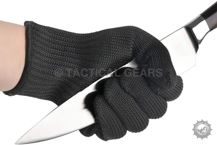 Black anti cut gloves holding a knife, showcasing durability and safety for cut protection