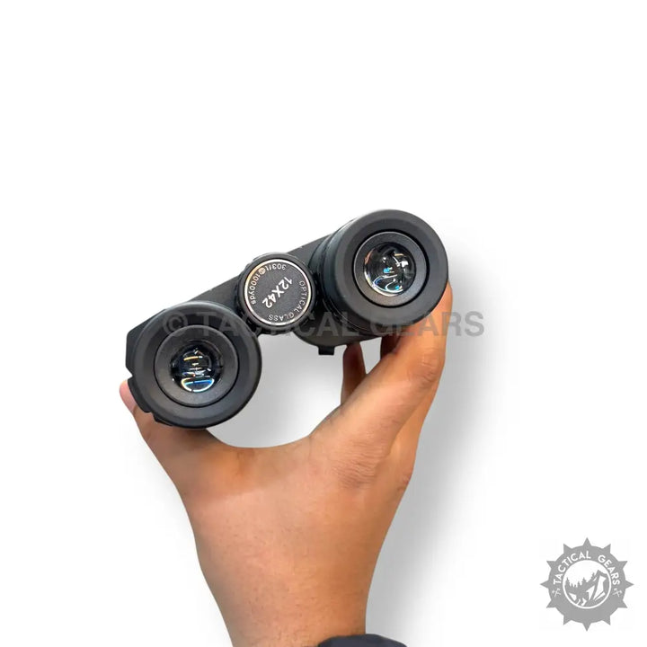 Black tactical portable binoculars with two objective lenses and central focusing wheel