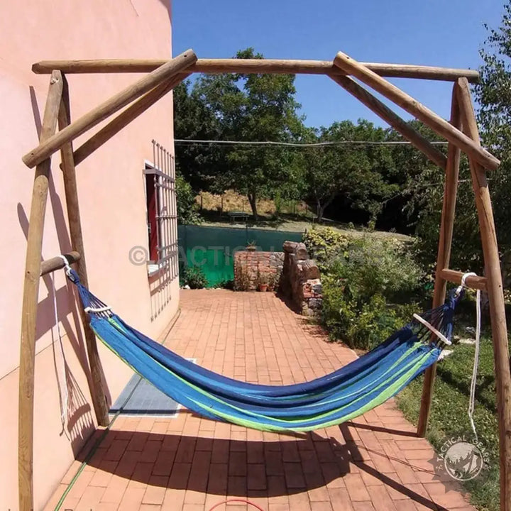 Blue and green striped hammock with wooden spread bars on a stand, perfect for relaxing in the garden
