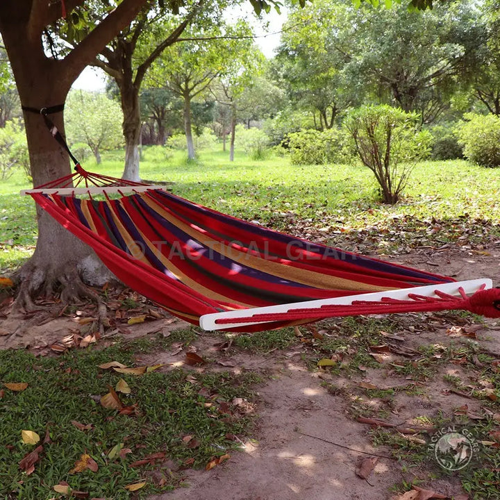 Red and blue striped hammock with wooden spread bars and travel bag for outdoor relaxation