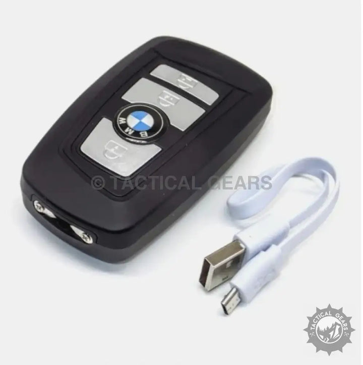 Black BMW-style key fob stun tool with integrated camera and USB cable for safety