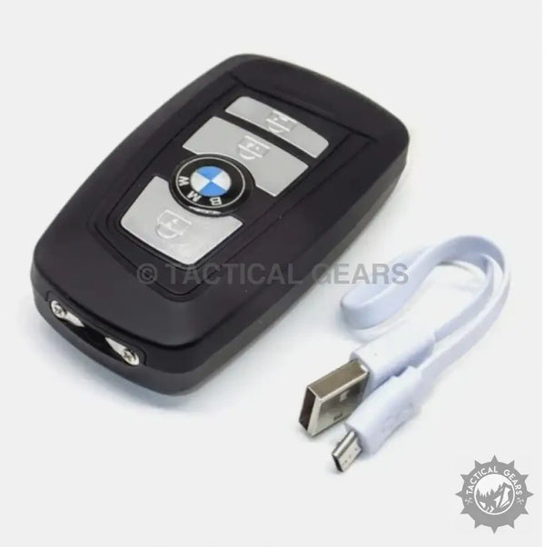 Black BMW key fob with USB charging cable, part of the BMW Self Defence 3-in-1 stun tool