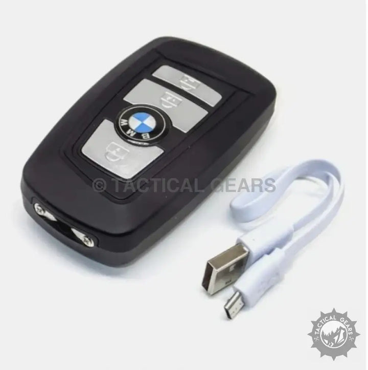 Black BMW key fob with USB charging cable, part of the BMW Self Defence 3-in-1 stun tool