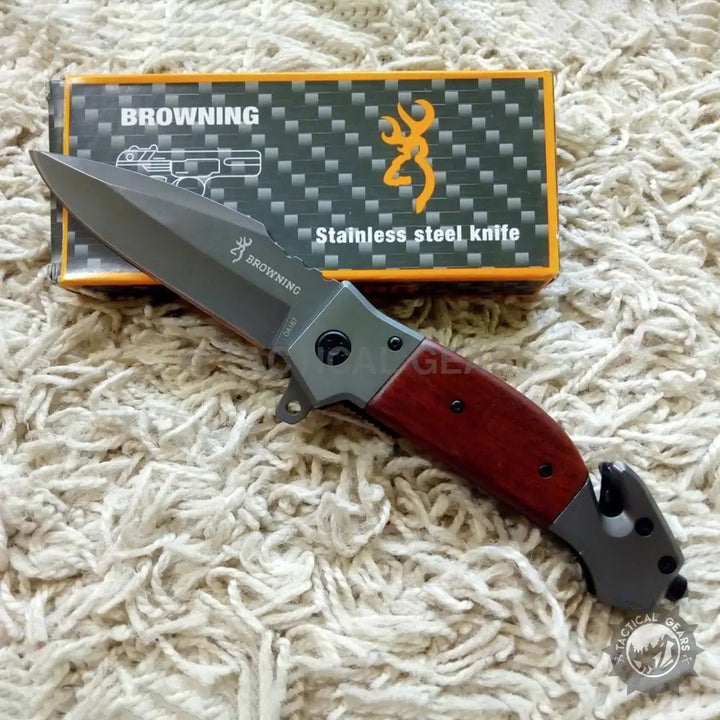 Browning DA167 folding knife with wooden handle and dark gray serrated blade