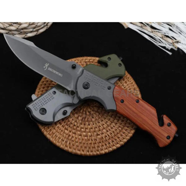 Browning DA308 tactical knife with gray blade, wood-grain handle, seatbelt cutter