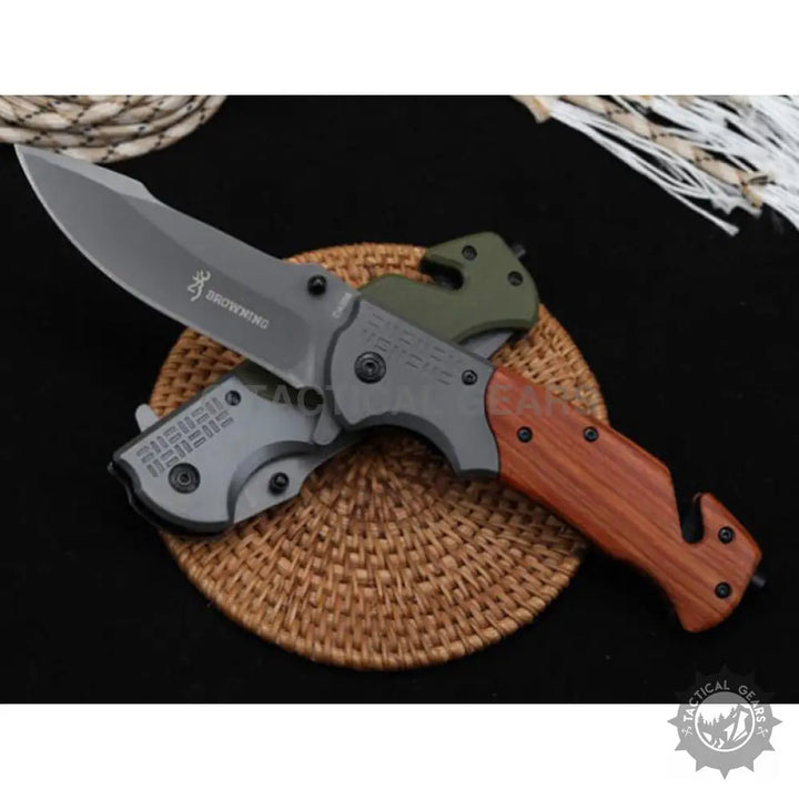 Browning DA308 tactical knife with gray blade, wood-grain handle, seatbelt cutter