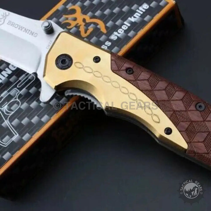 Browning DA77 titanium folding knife with white blade and brown handle