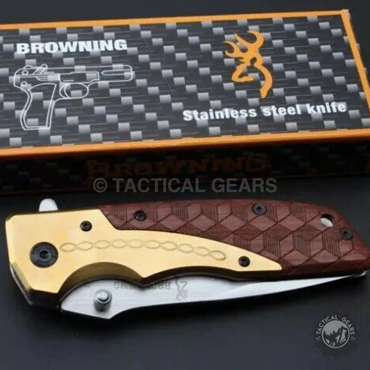 Browning DA77 titanium handle folding pocket knife with gold and brown accents