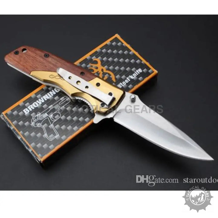Browning DA77 titanium folding knife with wooden handle and metallic blade