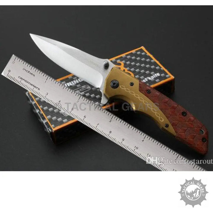 Browning DA77 Titanium folding knife with gold blade and brown textured handle