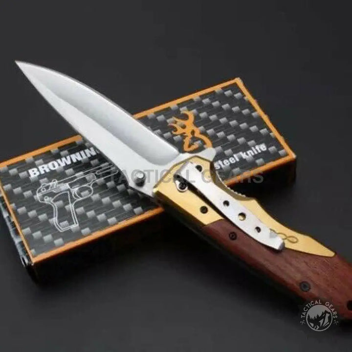 Browning DA77 titanium handle folding pocket knife with wood and gold accents