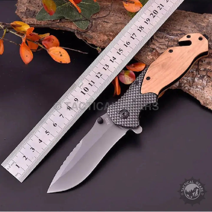 Browning X50 folding knife with light wood handle and dark textured grip