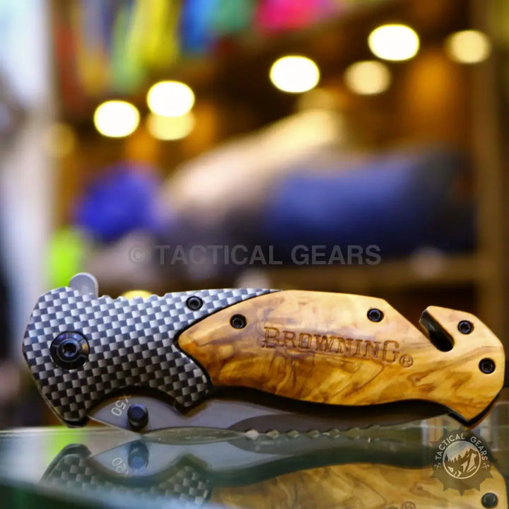 Browning X50 folding knife with carbon fiber pattern and wood-grained handle
