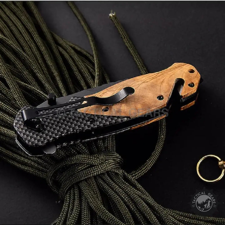 Browning X50 folding knife with carbon fiber wood handle, pocket clip, and rope cutter