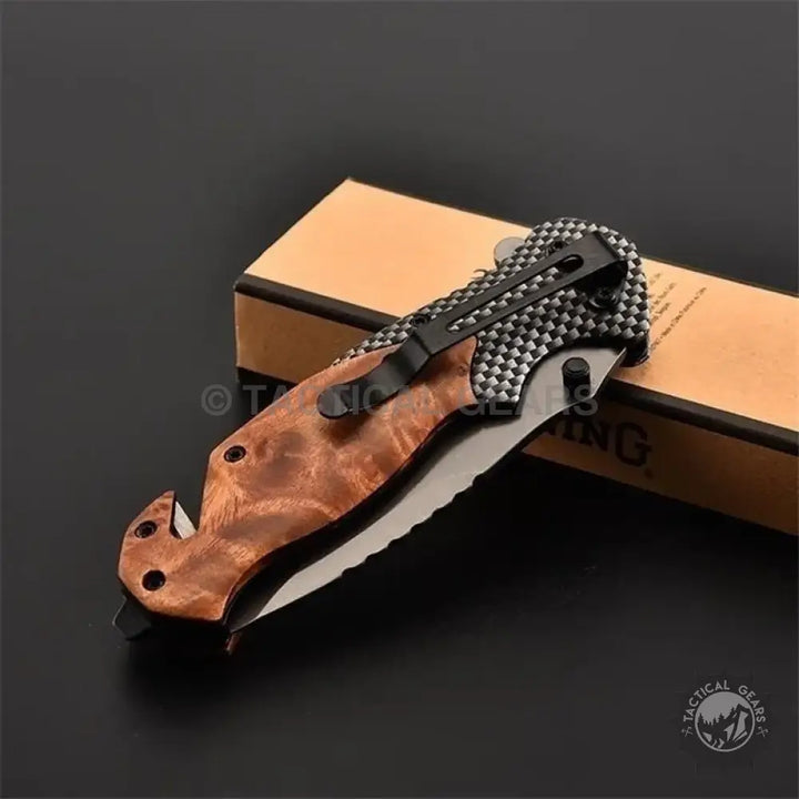 Browning X50 folding knife with wood handle, black pocket clip, and partially serrated blade