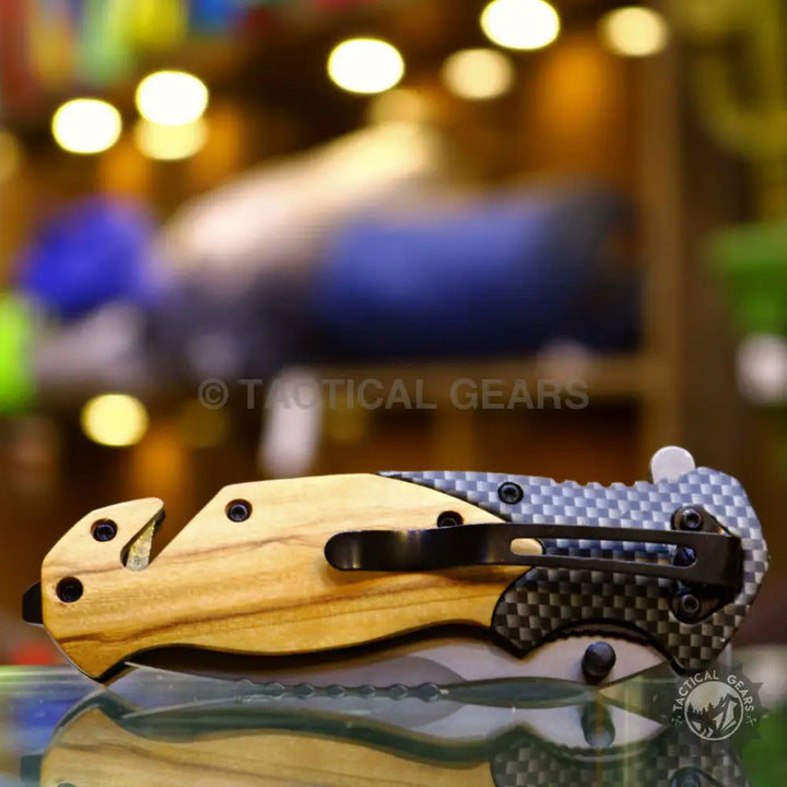 Browning X50 folding knife with wooden handle, strap cutter, and pocket clip