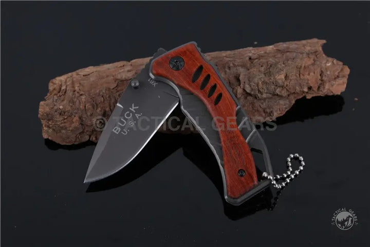 Black folding knife with red handle and ball chain, Buck USA X61 Tactical Pocket Survival Knife