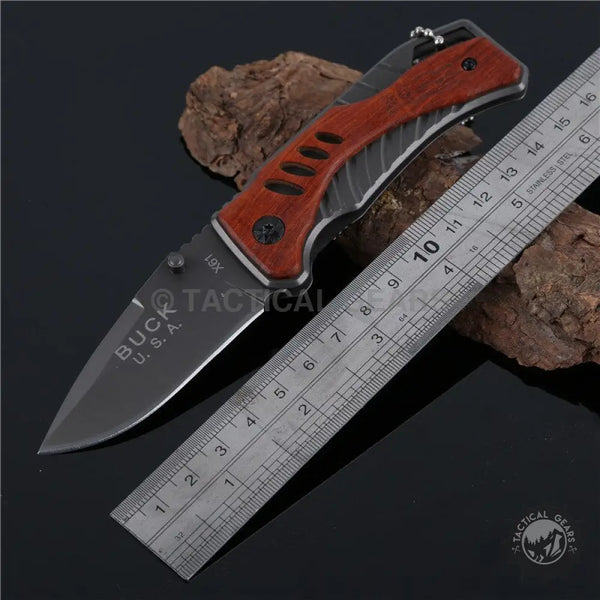 Buck USA X61 tactical pocket survival knife with dark blade and reddish-brown gray handle
