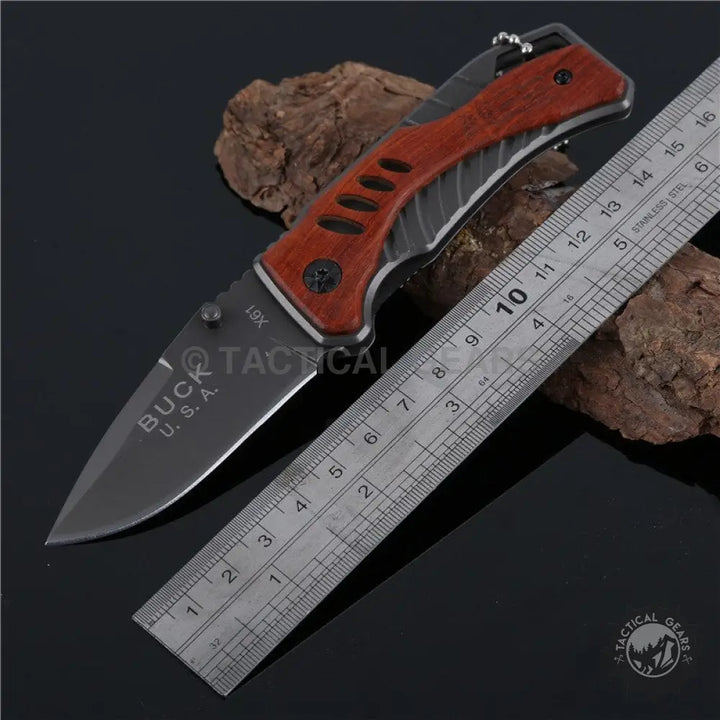 Buck USA X61 tactical pocket survival knife with dark blade and reddish-brown gray handle