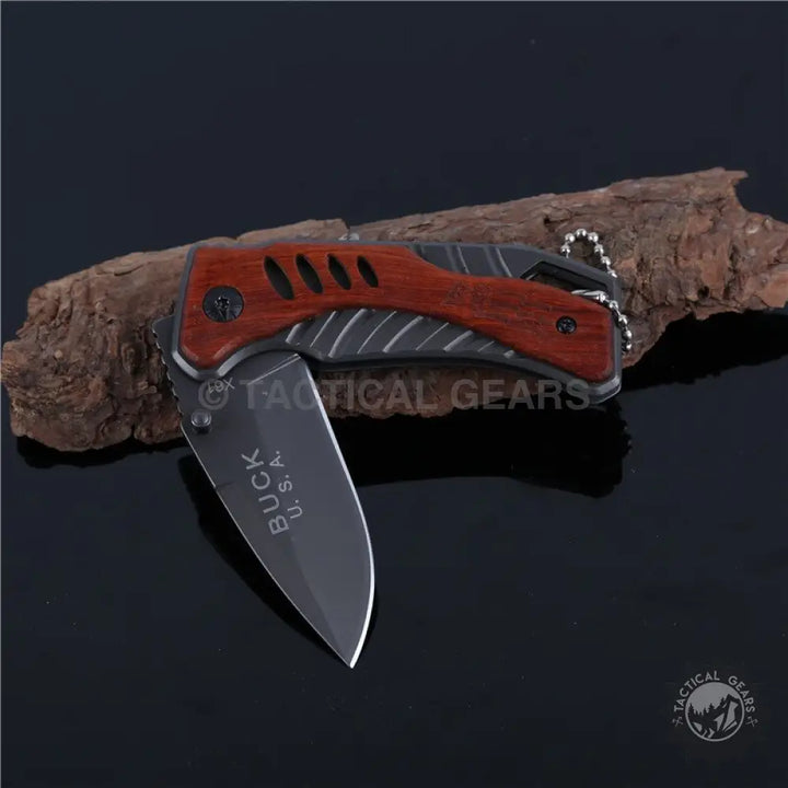 Buck USA X61 tactical pocket survival knife with dark blade and reddish-brown wooden handle