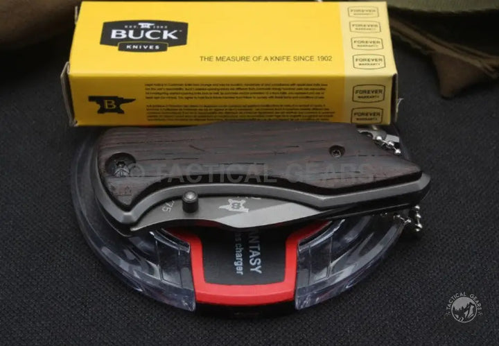 Black folding knife with dark wood handle on clear stand, Buck USA X75 Classic Mini
