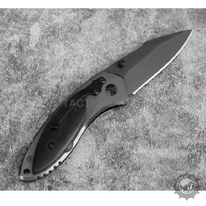 Black and grey Buck X11 Folding Knife with partially serrated blade measures for versatile use