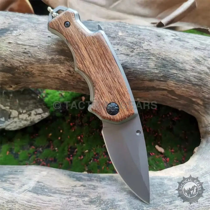 Buck X74 folding knife with wood-grain handle and grey blade for outdoor use
