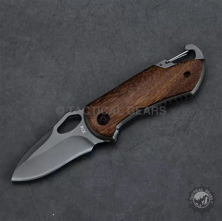 Buck X74 folding knife with dark wooden handle and integrated carabiner clip