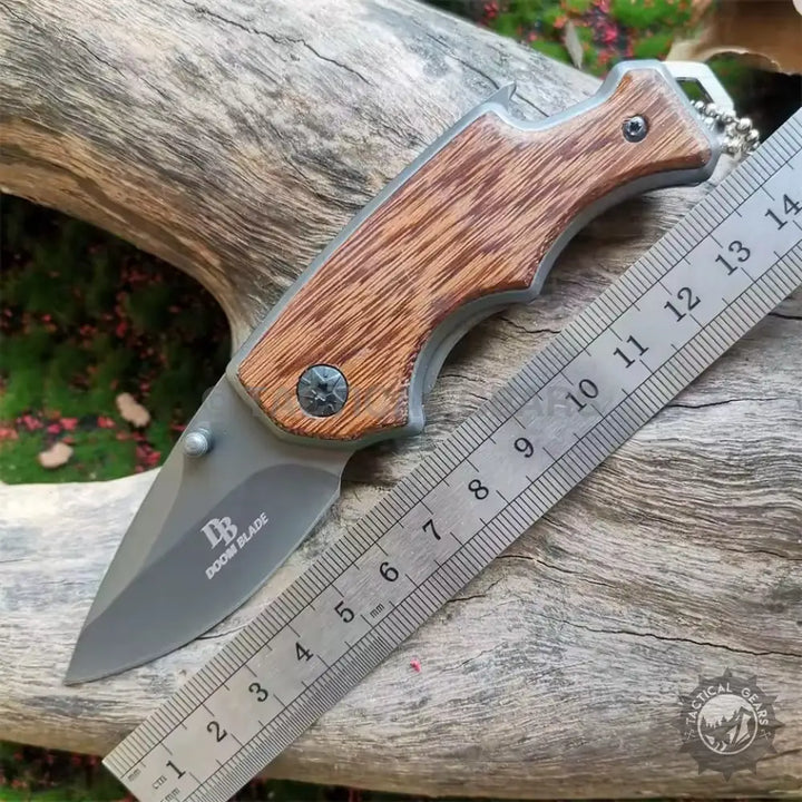 Buck X74 folding knife with wooden handle and metal ruler for versatile use