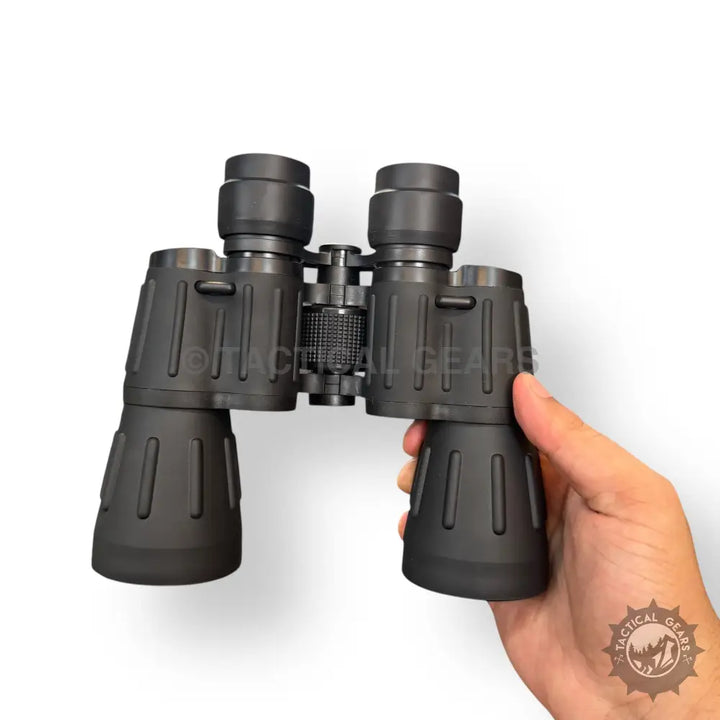 Black Bushnell 70x70 binoculars with central focusing knob, case, and original box