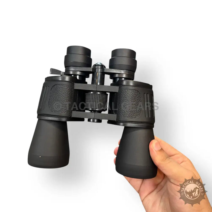 Black Bushnell 70x70 binoculars with textured grip and central focus wheel in case