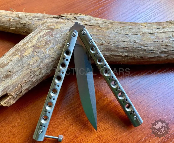 Butterfly Knife Silver Steel with dark blade and silver handles featuring circular cutouts