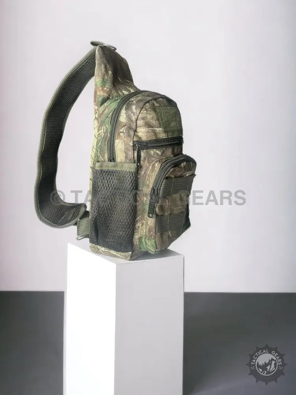 Camo hunting sling bag with multiple zippered pockets and mesh side pocket