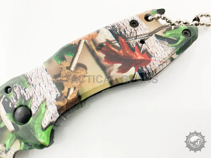 Camo-patterned Buck X75 Hunting Knife with 00cm blade and keychain attachment