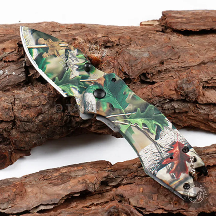 Camo-patterned folding Buck X75 Hunting Knife with 00cm blade and clip for outdoor use