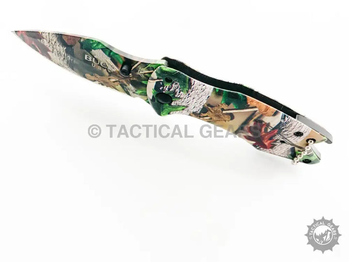 Buck X75 Camo Hunting Knife with folding design, camouflage handle, and 00cm blade