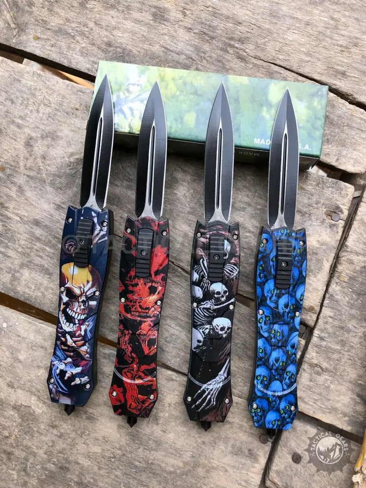 Four combat OTF knives with skull and skeleton patterns on carbon fiber handles