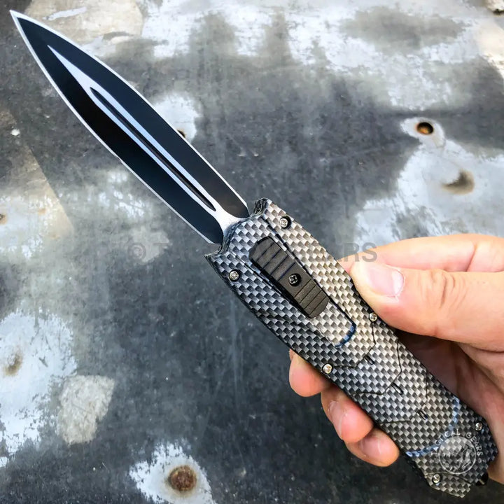 Black and silver dagger-style Combat OTF knives with carbon fiber handle and pocket clip