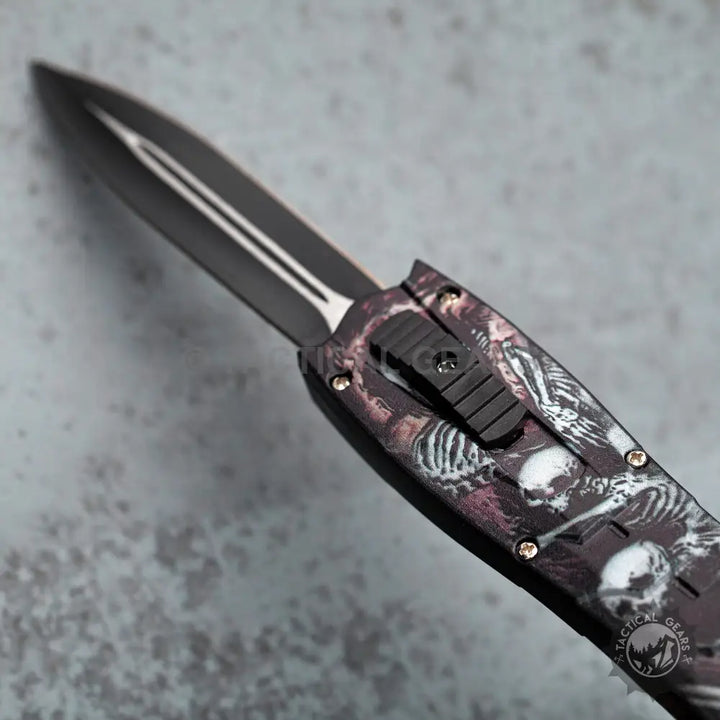 Black double-edged automatic knife with skeleton handle in combat otf knives collection