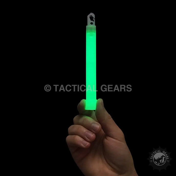 Hand holding a glowing green Chemlight Chemical Light Stick with hook at top