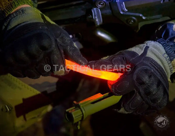 Two gloved hands holding a glowing orange Chemlight Chemical Light Stick for safety and visibility