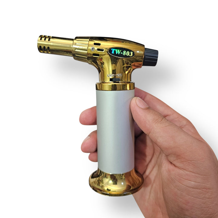 Gold and silver handheld butane torch cigar lighter, an imported cigar accessory