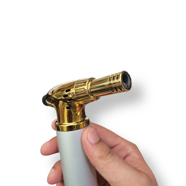 Imported cigar lighter with gold and silver finish and black igniter button