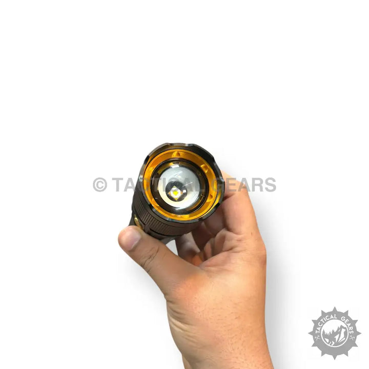 Hand holding Coba Aluminum 2km Tactical Flashlight with black and gold LED design