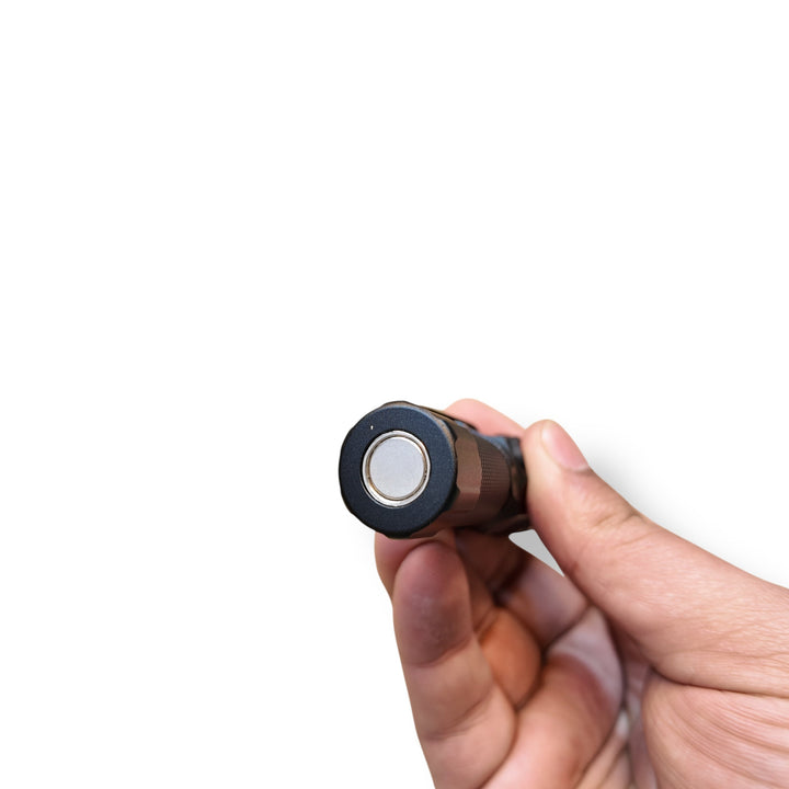 Black cylindrical Coba Mini Rechargeable LED Flashlight with silver face in hand