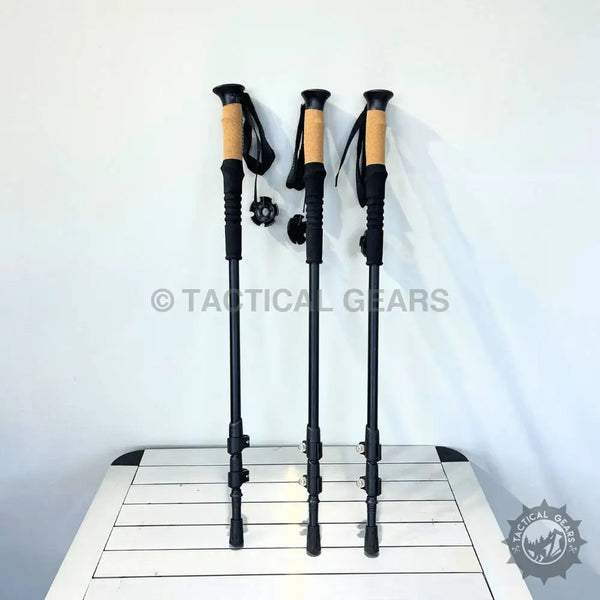 Three black and tan adjustable trekking poles with ergonomic grip for Mountaineering Hiking Stick