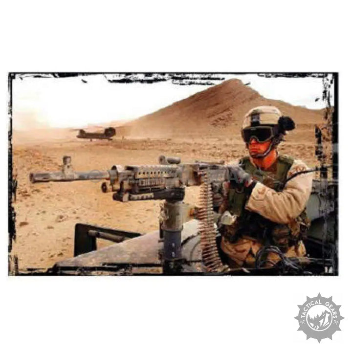 Soldier in desert camouflage using combat military spectacles with mounted machine gun